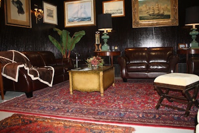Two sitting areas are furnished with the comforts of home: leather seating, Oriental rugs, artwork, and lamps.