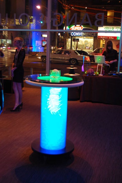 Glowing cocktail tables from Furnishings by Corey added to the neon theme.