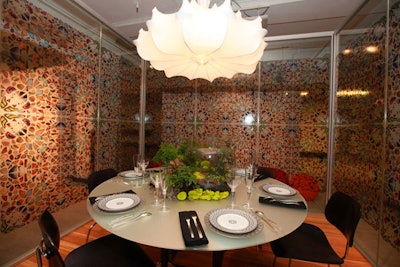 Butterflies adorned the wall at the table from Herman Miller by Gensler, and the centerpiece looked like a terrarium.