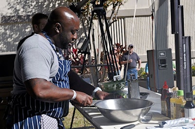 Chef Kenny Gilbert, a former contestant on Bravo TV's Top Chef, prepared curried salmon poke lettuce wraps onstage Sunday afternoon.