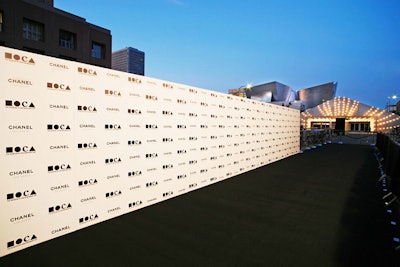 A long step-and-repeat wall served as the entry point in front of a 240-foot-long dinner tent.