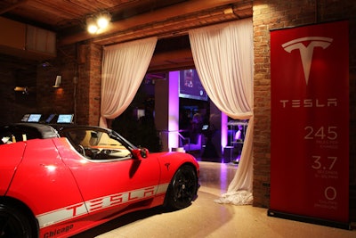 An on-site Tesla promoted a live auction package that let the highest bidder spend a weekend with the car.