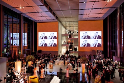 The courtyard's 63-foot-high walls doubled as real-time gallery space, as guests snapped photos in the on-site photo booth, which were then projected onto large screens.