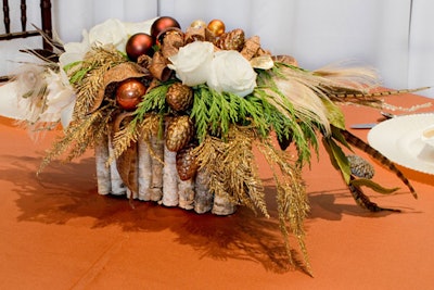 Kehoe Designs' holiday-party decorations incorporate birch, pheasant feathers, and gold-dipped pinecones.