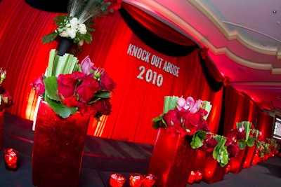 Andre Wells decked the Ritz-Carlton ballroom with floor-to-ceiling red velvet and a plethora of rose-accented arrangements for Knock Out Abuse's gala.
