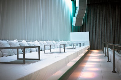 Bedlike seating lines the dance floor.