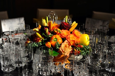 Kitchen utensils and red and yellow peppers accented the table centrepieces, designed by Eric Aragon of Solutions With Impact and created by San Remo Florist.