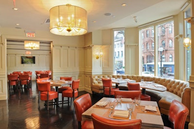 The restaurant's main dining room, 'the living room,' has windows overlooking Newbury Street and red and taupe leather upholstery against neutral walls.