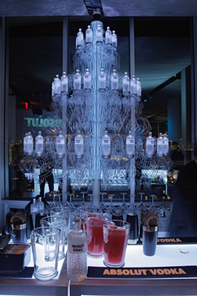 Inspired by the 1,900-piece Louis XV fixture that hangs in the Downtown by Philippe Starck building—also known as the 'chandelier of insanity'—Extra! Extra! created an oversize chandelier for the event. The installation was embellished with Absolut Glimmer bottles and stood behind the bar at the cocktail reception.
