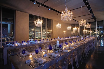 To complement the texture of the bottle, the producers decorated the dinner area with custom chandeliers and candelabra, tables covered in silver vinyl, and transparent chairs.