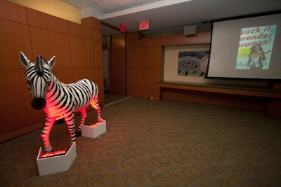 The House Party brought in props and decorations to Random House Publishing Group's offices, contrasting a live feed of the more formal National Book Awards event with a life-size zebra, string lights, and bright-colored centerpieces for the cocktail tables.