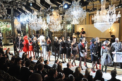 Set designer Shona Heath helped create the look of the show, which included a 50-foot runway covered in a hand-painted canvas inspired by the Cotillion Room's wall paneling. To recreate an authentic Parisian haute couture experience, the producers also hung 20 chandeliers at varying heights from the ceiling.