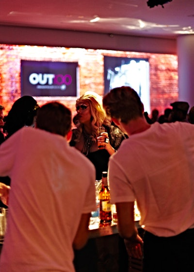 Following the Black and White Ball look, the video switched to highlight the era of the Stonewall riots, using photos of brick building facades to give the impression of the West Village. Bartenders and waiters changed from bow ties and masks into T-shirts, fake mustaches, and aviator sunglasses to match the theme.