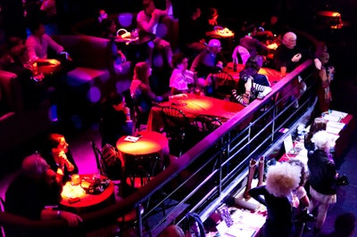 Some of the 100 guests sat at tables in a cocktail area raised above the dance floor.