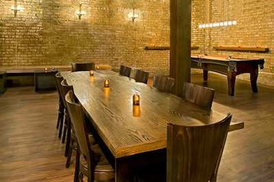 The rustic venue is outfitted with exposed brick walls and dark wood fixtures.