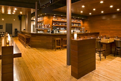 The focal point is a wraparound bar made of salvaged wood. The drink list offers 70 kinds of beer and specialty craft cocktails with names like 'Ol' Chum.'