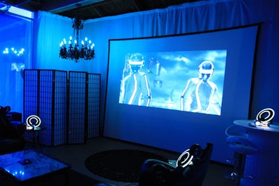 A folding screen, black chandelier, and projections contribute to the futuristic look in the space.