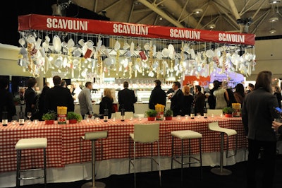 For the Interior Design Show's opening-night party, event producer Marion Heintzman of Heintzman Productions displayed items like cheese graters, strainers, and dishes on a massive kitchen rack above the main bar, sponsored by Scavolini.