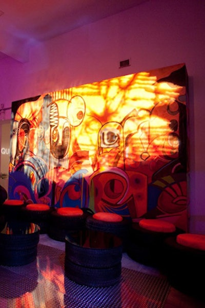 In the area for the 'street' boutique, a 24-foot-wide custom-painted graffiti mural in hot pink, orange, and streaks of turquoise served as the backdrop for the interactive space. A seating banquette was comprised of tires with custom orange cushions.