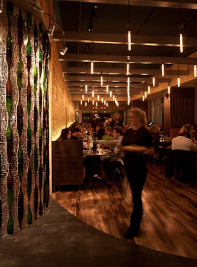 A bottle-and-glass mosaic greets guests at the entrance and separates the dining room and the bar area.