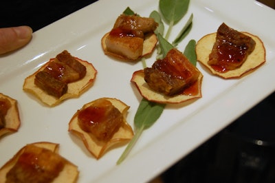 Servers passed hors d'oeuvres like vegetable ceviche and pork belly on apple crisps.