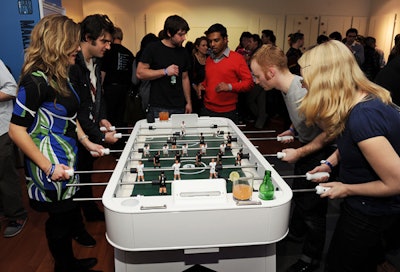 Set up as a gaming lounge, the lower level has products visitors are encouraged to touch and play with, including a foosball table.