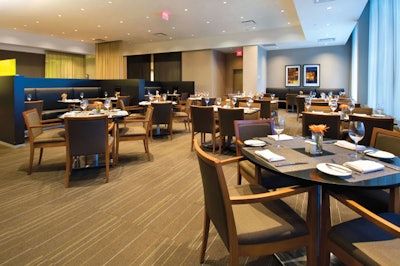 Designed by Cecconi Simone, Bliss Restaurant & Bar features warm wood tones, sheer drapery, and semiprivate booths.