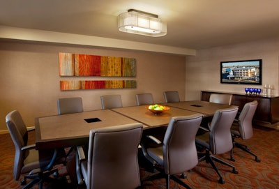 The Barbados Boardroom has flat-panel screens, leather executive chairs, and a conference table.