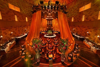 Four gold silk organza panels rigged to the overhead chandelier draped the center of the venue, creating a semi-enclosed V.I.P. area.