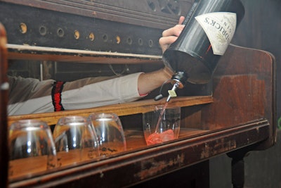 At another station, a mixologist poured drinks from inside a piano.