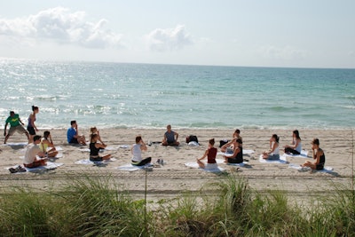 During the Hotel Thrillist promotion at the Fontainebleau, Equinox Fitness Club conducted morning yoga sessions, one of many activities throughout the weekend, on the beach behind the hotel.