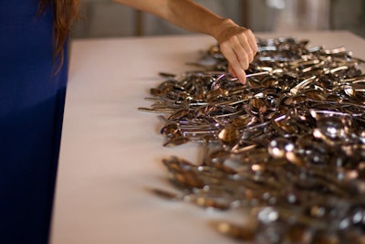 In another room, Rubell placed 4,000 silver spoons on a white pedestal.