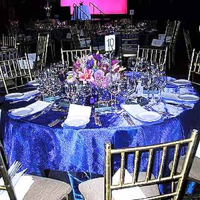 Design Fusion put out colorful floral centerpieces on glittery blue tablecloths on the dinner tables.