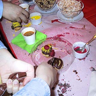 Caterer the Cleaver Company helped the children at the party decorate cupcakes.