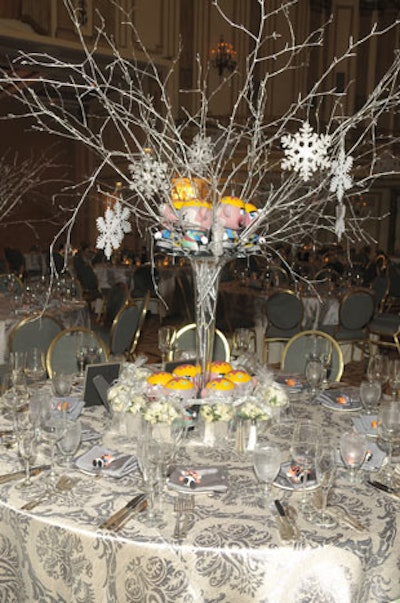 Centerpieces held silvery branches and snowflake ornaments, and no cut flowers.