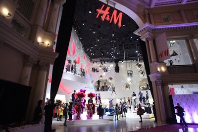 For its Forum Shops opening, the new H&M store boasted giant rotating disco balls, H&M-attired mannequins hanging from trapeze bars, and architectural shard cutouts—all visible from the store's entrance.