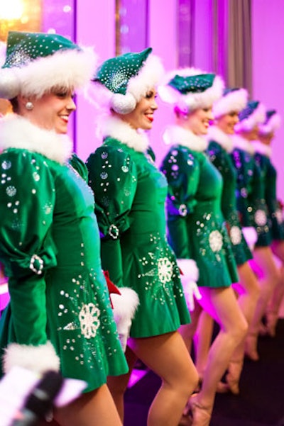 Rockettes, dressed in the traditional green velvet costumes from the Christmas Spectacular, lined up on the runway.