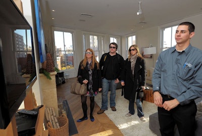 The cable company's personal solutions advisors and connection specialists staffed all areas of the home (including the living room, pictured), guiding visitors through the technology and solutions to common problems.