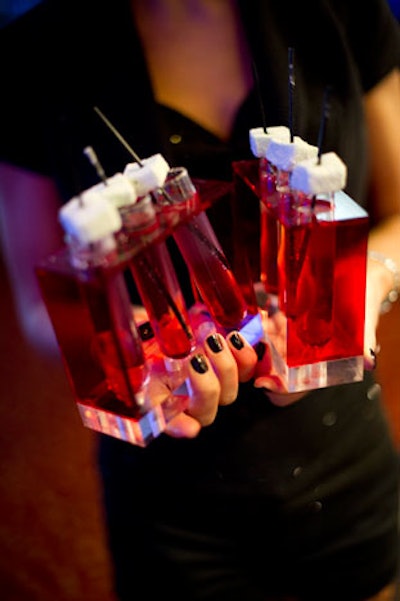 Cocktail waitresses served pomegranate champagne shooters topped with mint marshmallows as one of five signature cocktails at the party.