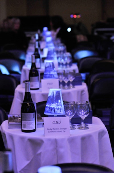 Rows of tables filled Symphony Hall's floor, decorated with lanterns by Balloon Events Boston and wine to accompany the boxed dinners provided by Boston Gourmet.