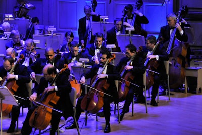 The Pops orchestra, awash in blue light, played several classic Christmas songs, lending the signature festive vibe to Symphony Hall that the Holiday Pops concert is known for.