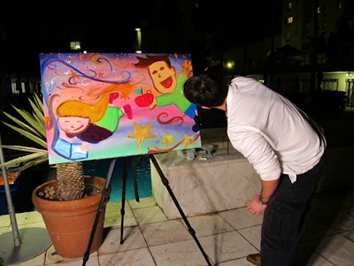 Artist Juan 'Fane' Carbonell painted live, inspired by the Motivational Edge kids and the holidays.