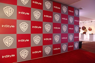 Logos covered a press wall in a checkerboard style.