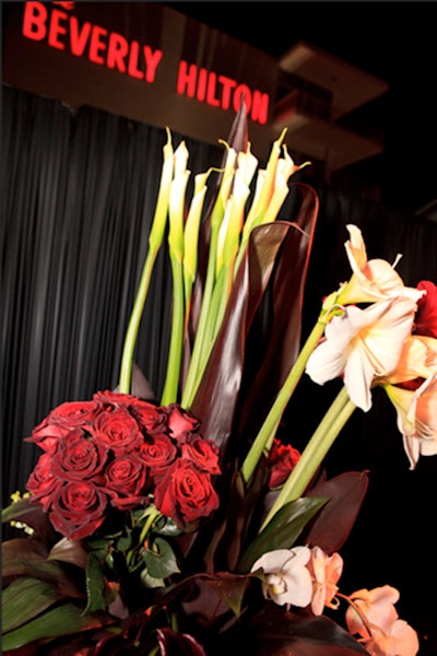 Roses, callas, and succulents mixed in floral centerpieces.