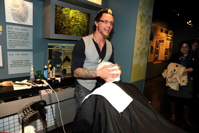 A stylist from the Suite Barbershop provided shaves for men in the C.S.I. Experience exhibit.