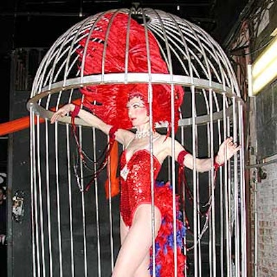 Human 'go-go birds' in cages from Opening Nite Entertainment danced for guests.
