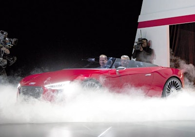 Audi AG's Chairman Rupert Stadler drove on to stage for his keynote speech in the company's prototype, all-electric eTron sports car.