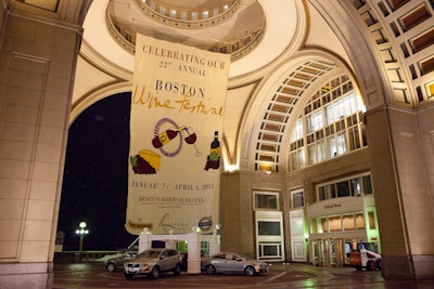 A Boston Wine Festival logo banner hung outside the hotel over the newest Volvo models, highlighting event sponsors.