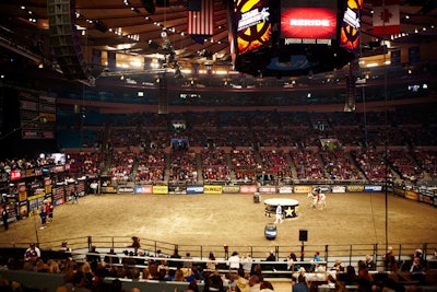 Originally meant to house photographers shooting the bucking bulls, the 'shark cage' in the center of the arena this year had a lid placed on top, creating create a stage that doubled as a safety zone and entertainment spotlight for the M.C. following the pyrotechnic display.