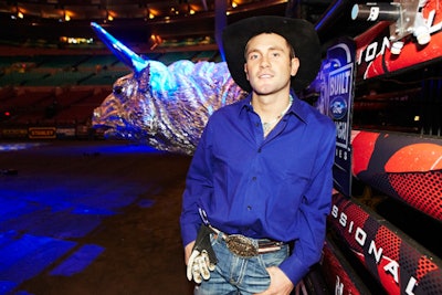 2010 Professional Bull Riders New York winner Shane Proctor stood adjacent to two chrome-plated bull heads, made of heavy-duty papier-mâché, that were hung at the base of the stage.